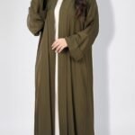 Olive open abaya with wide cuffed sleeves, worn over an ivory dress