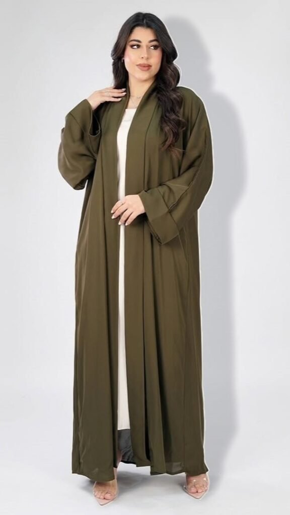 Olive open abaya with wide cuffed sleeves, worn over an ivory dress