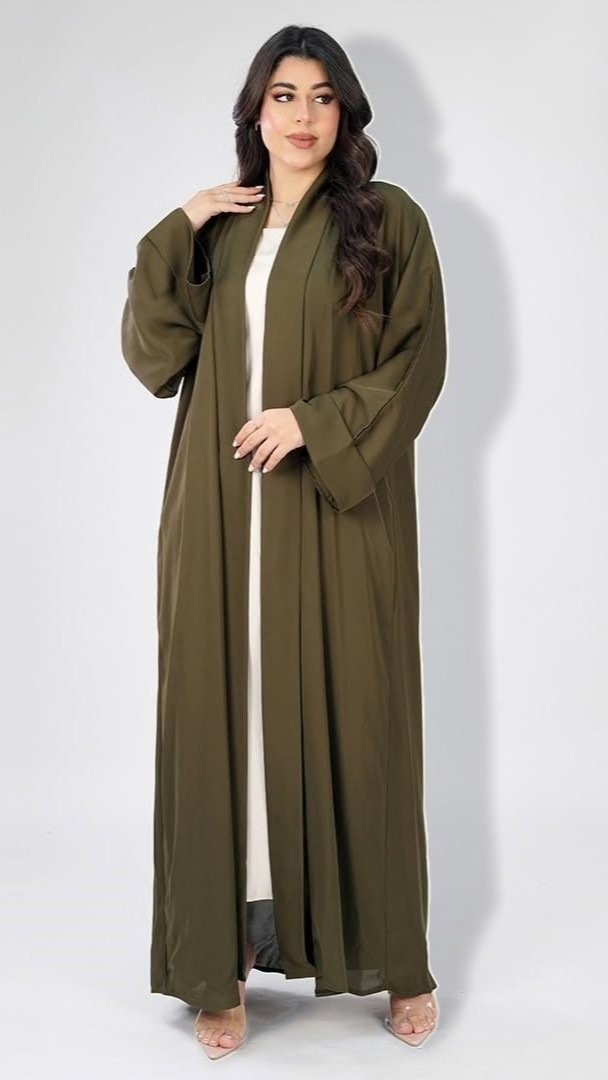 Olive open abaya with wide cuffed sleeves, worn over an ivory dress