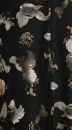 Close-up of the silver-grey and bronze floral print on black fabric