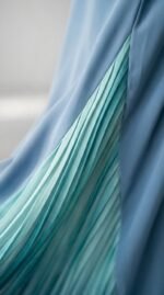 Close-up of the teal pleated panel set into the blue nida fabric