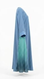Side view of the blue nida abaya showing the teal pleated panel and folded cuff